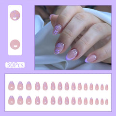 HJKDSFD flower design nails closeup showing vibrant purple blossoms and glossy finish.