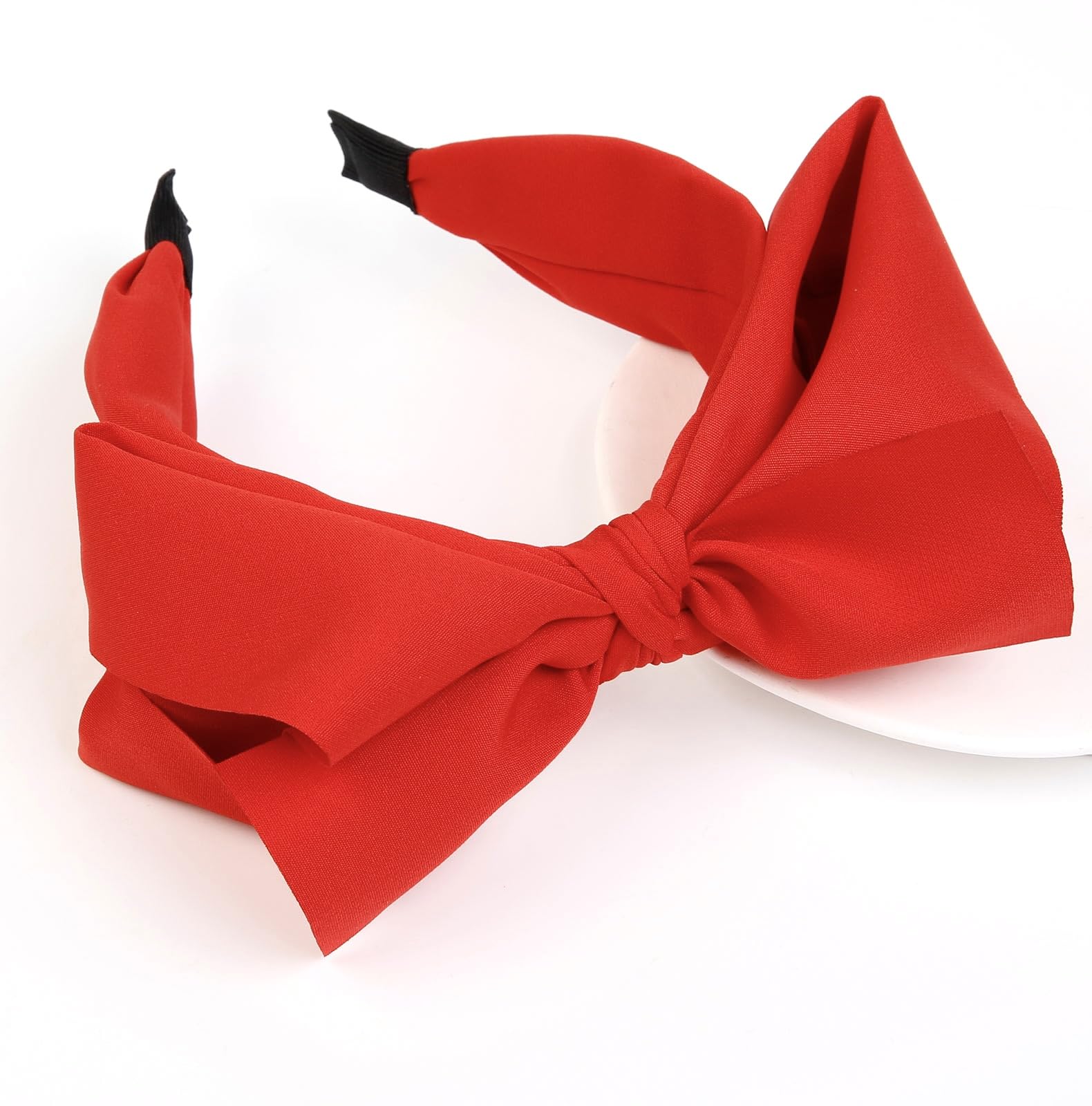 Huachi red bow headband worn on head shows secure all-day comfort.