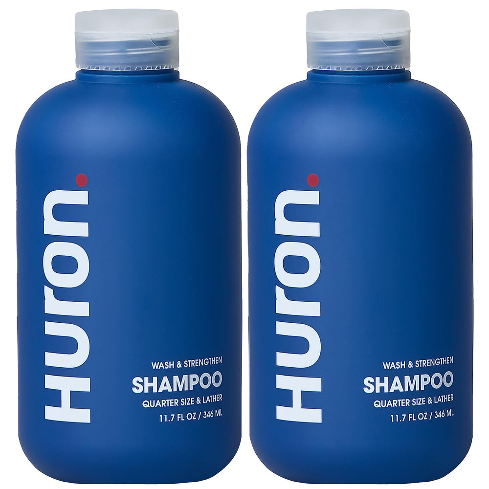 Huron Clean Citrus Woods shampoo bottle promotes sulfate-free nourishment for daily refreshment.