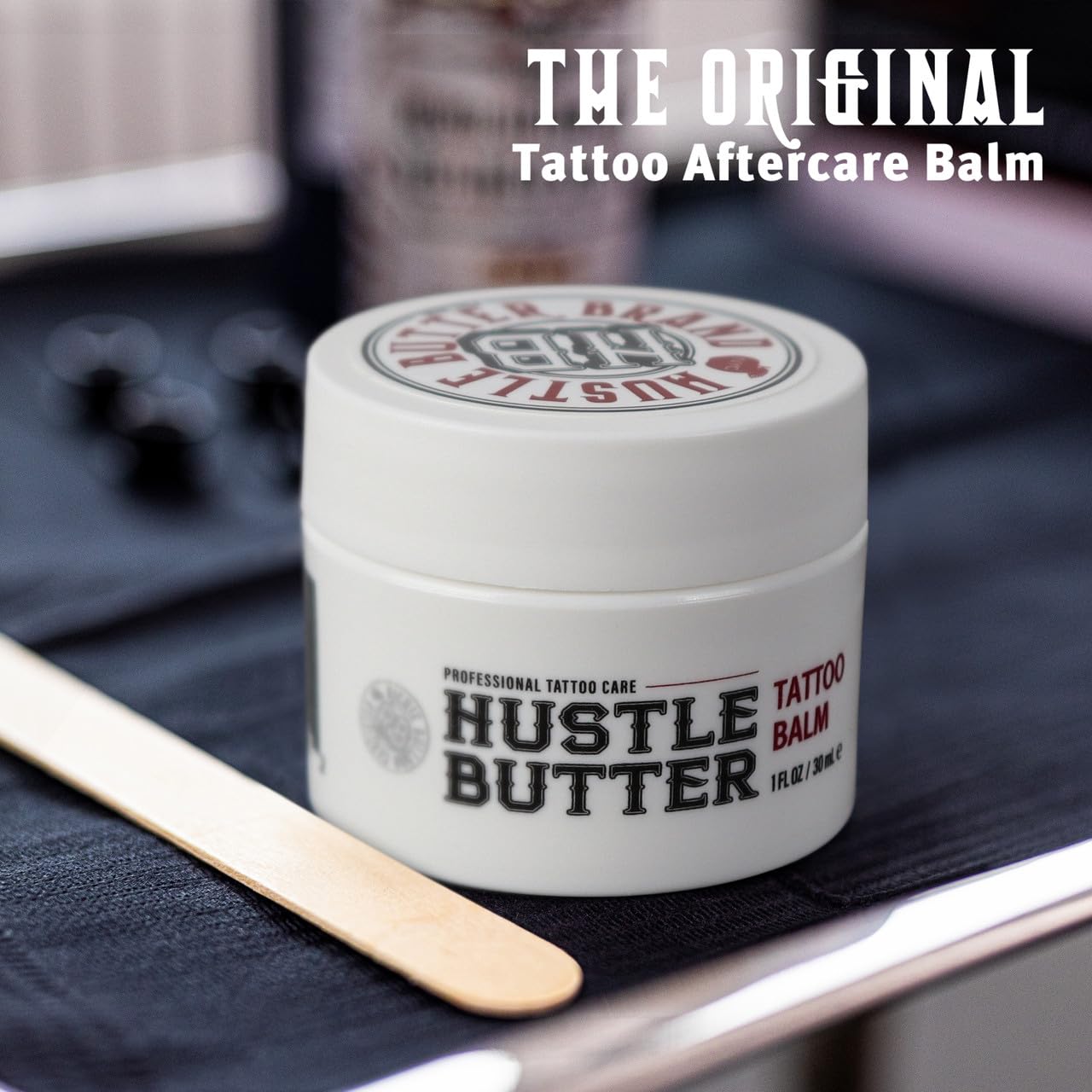 Hustle Butter Deluxe creamy-texture close-up highlights natural ingredients like shea and coconut for moisture.