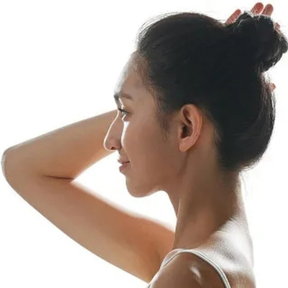 Hyamass spiral pins on dark hair for a discreet, sleek finish.