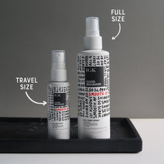 IGK Good Behavior bottle close-up demonstrates even spray for smooth application.