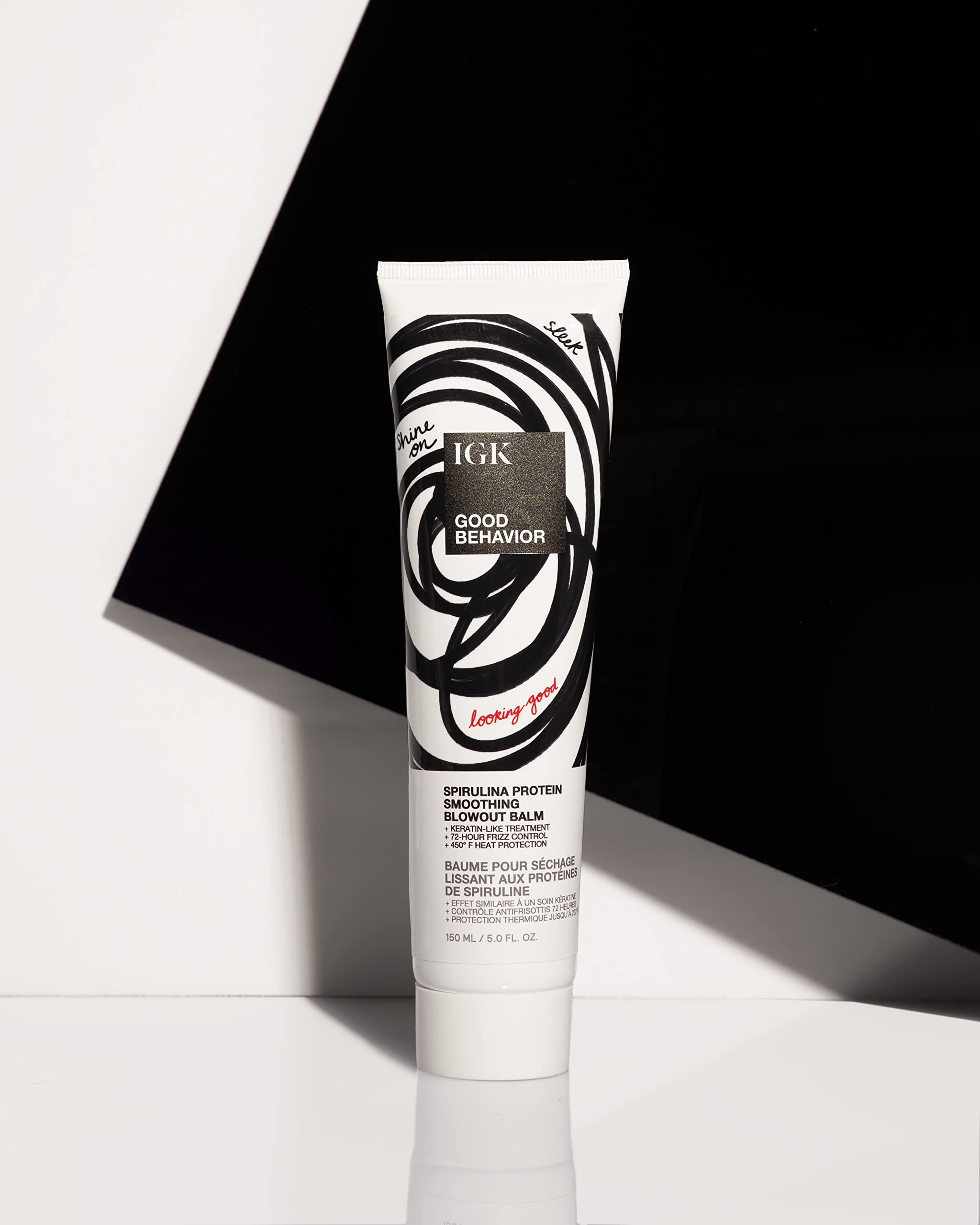IGK Good Behavior balm being dispensed onto palm demonstrates even distribution.
