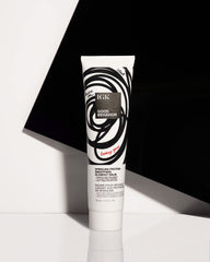 IGK Good Behavior balm being dispensed onto palm demonstrates even distribution.