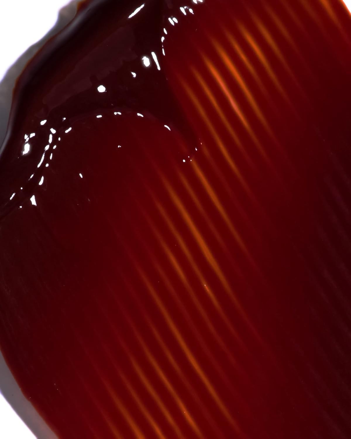 IGK Hair Gloss Toner Williams Burgundy closeup-texture shows nourishing gloss and smooth strands.