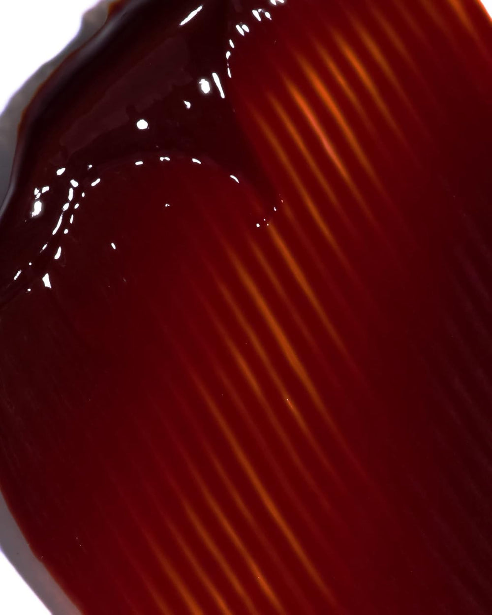 IGK Hair Gloss Toner Williams Burgundy closeup-texture shows nourishing gloss and smooth strands.