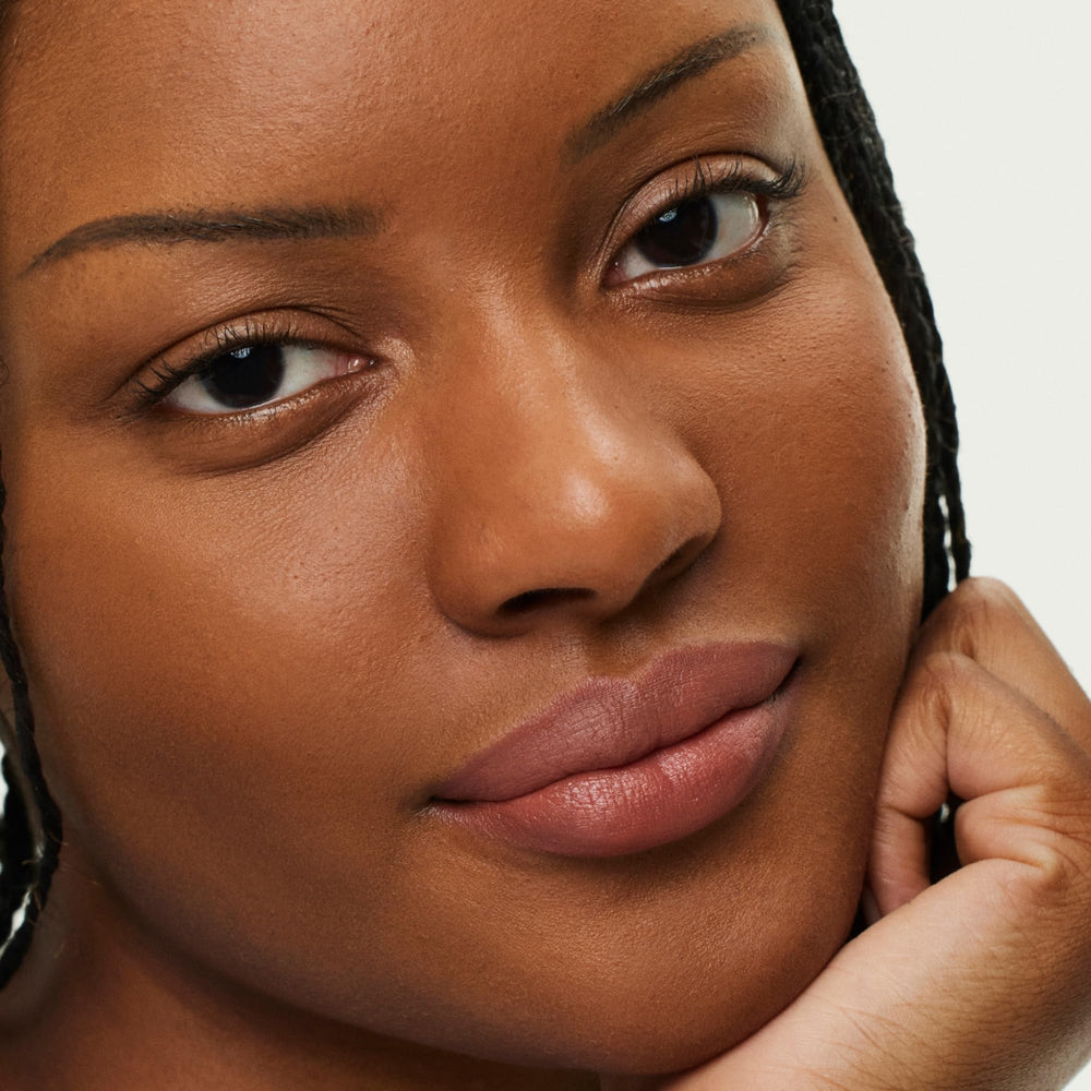 Lip swatch demonstrates hydrated plump look in Earthen shade