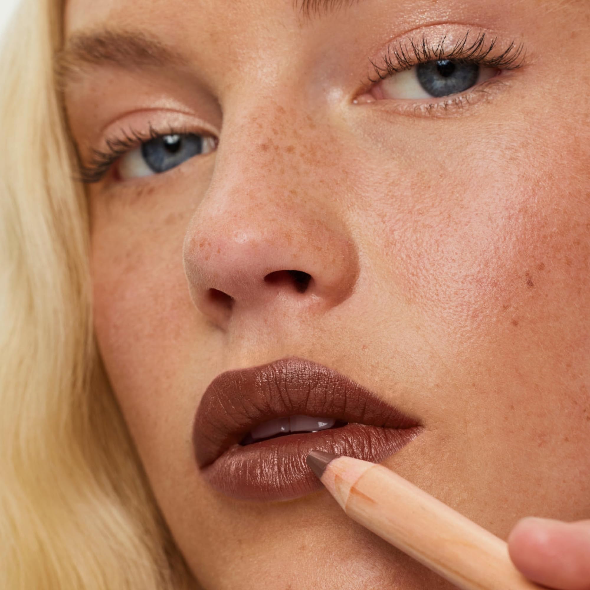 ILIA Lip Sketch Tableau brown swatch close-up highlighting defined lips.