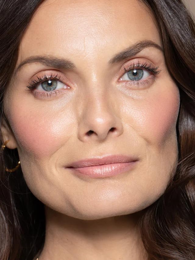 ILIA Multi-Stick Golden Peach shade on lips for natural glow.