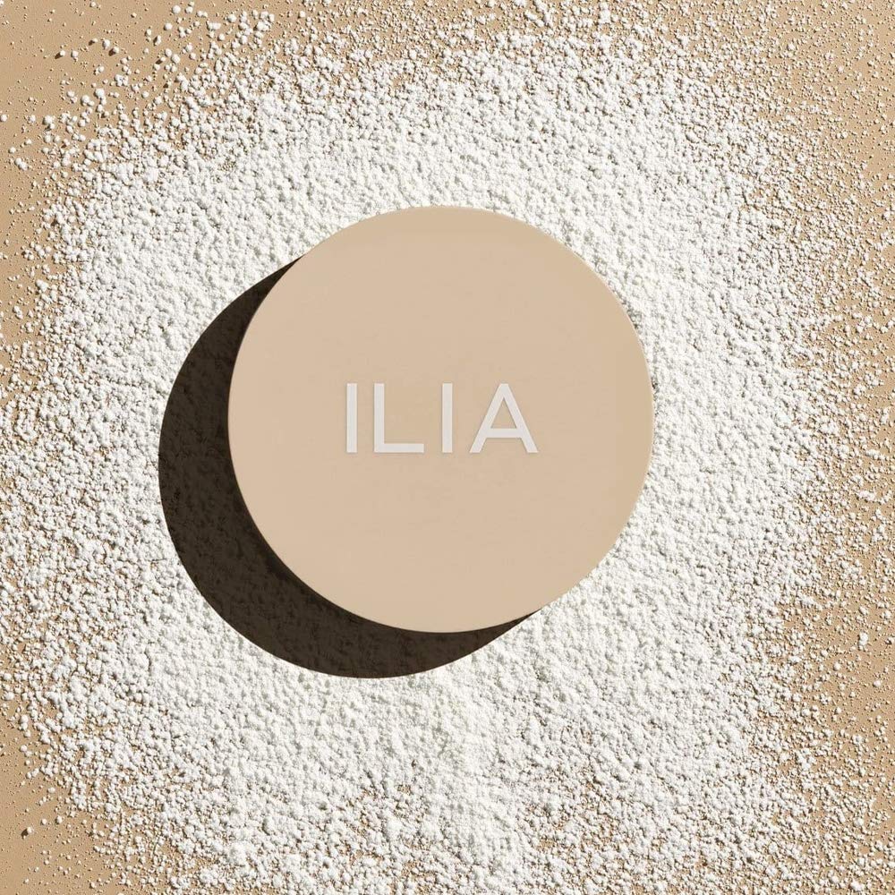 ILIA translucent powder on cheek offers soft-focus glow for healthy luminosity.