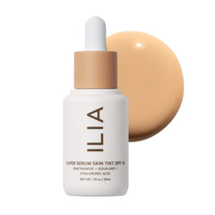 ILIA Super Serum Skin Tint bottle closeup shows a dewy finish and SPF 40 protection.