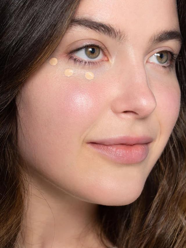 Close-up of ILIA concealer creamy texture ready to blend.