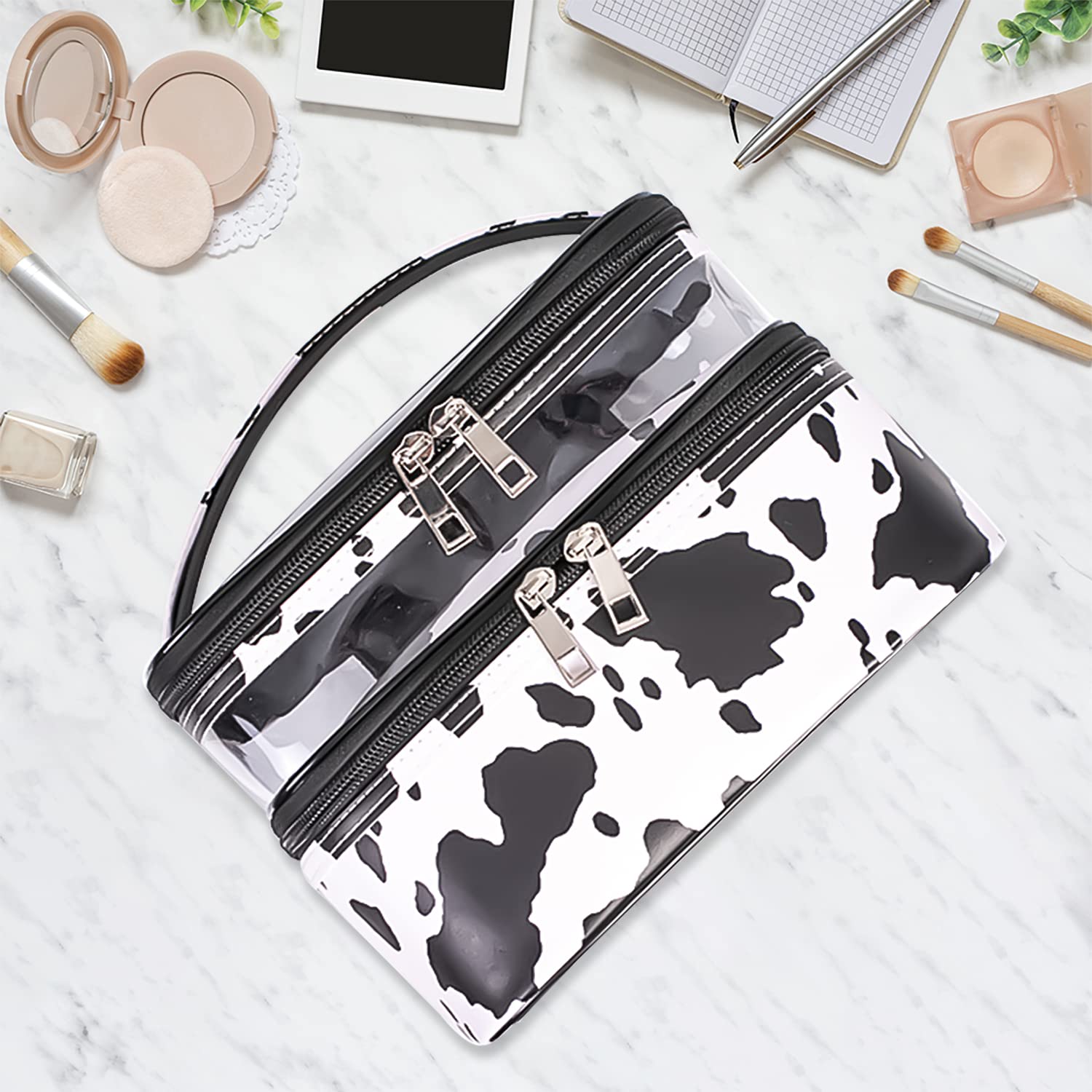 Imerelez cow print makeup bag side view highlighting waterproof exterior for travel.