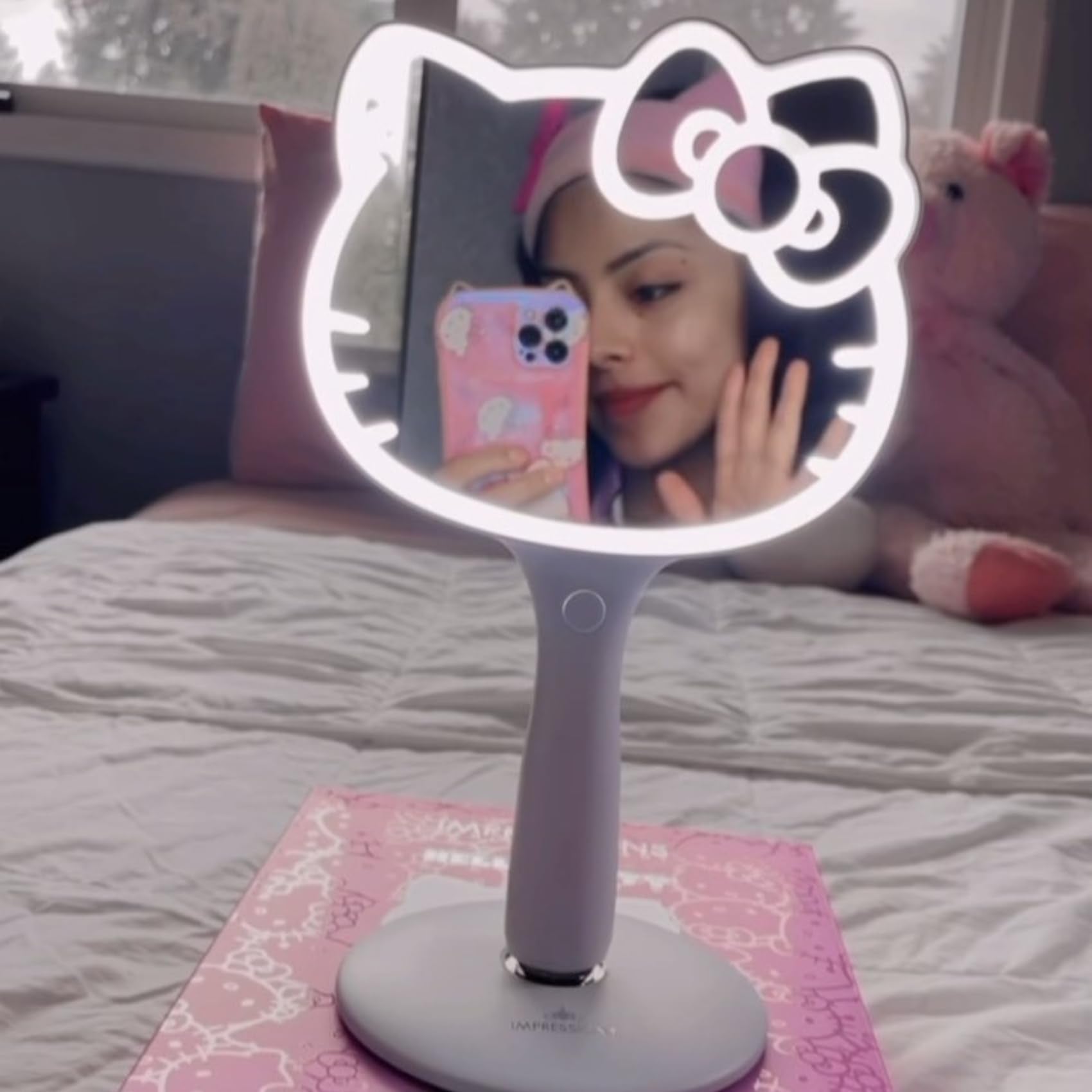 Impressions Vanity Hello Kitty LED Handheld Mirror on standing base enables hands-free use at vanity