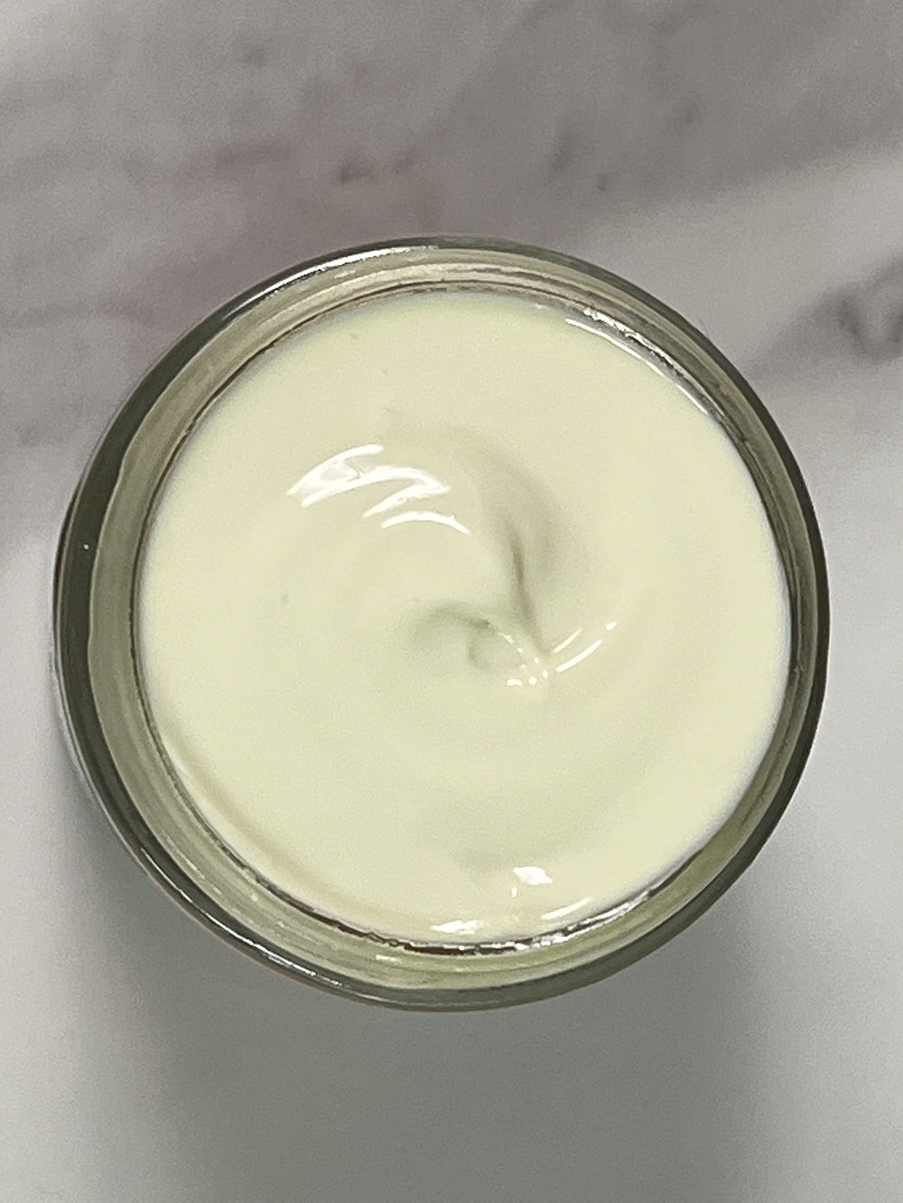 Indian Meadow Herbals Love Your Face Cream swirl on skin demonstrates deep penetrating hydration.