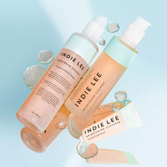 Indie Lee Brightening Cleanser glass bottle on vanity for daily use.