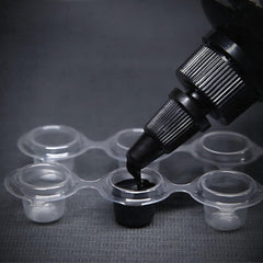Intenze Black Label ink bottle-cap closeup – secure cap supports hygienic sessions.