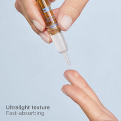 ISDIN Isdinceutics booster ampoules being opened for convenient single-dose application.
