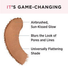 IT Cosmetics bronzer being applied with brush for a seamless flush.