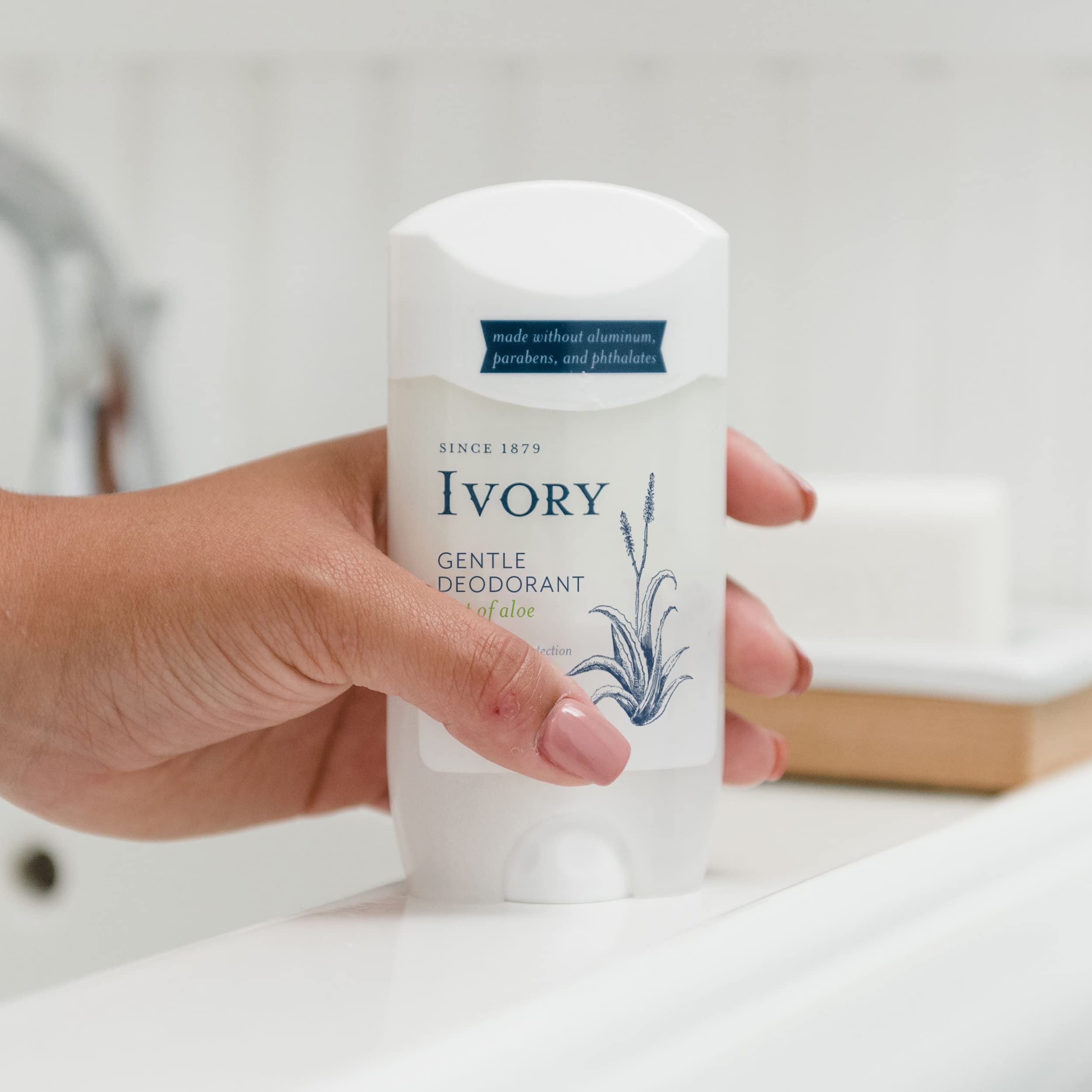 Ivory deodorant with aloe bottle close-up highlights soothing fragrance.