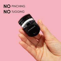 JAPONESQUE Travel Eyelash Curler in black demonstrates portable lash curling for travel-ready lashes.
