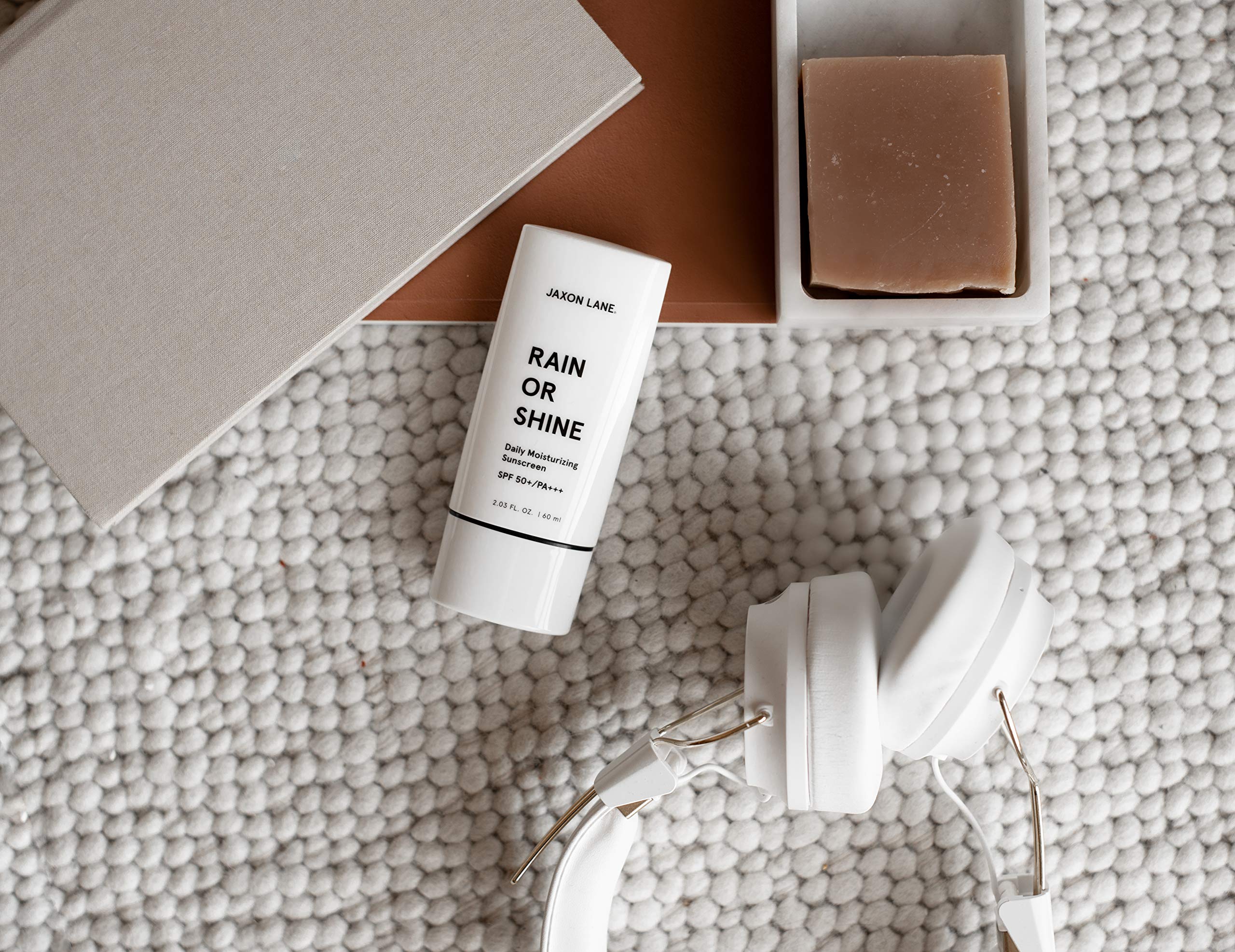 JAXON LANE Rain or Shine product on skin illustrating fast absorption.