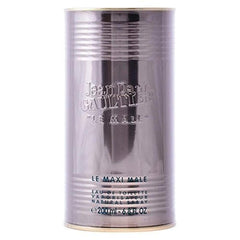 Jean Paul Gaultier Le Male ad captures iconic bottle in warm lighting.