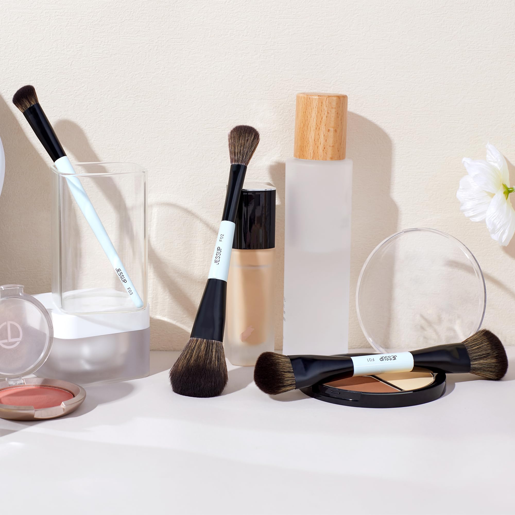 Jessup brushes versatility on face, enabling foundation, contour, and concealer application.