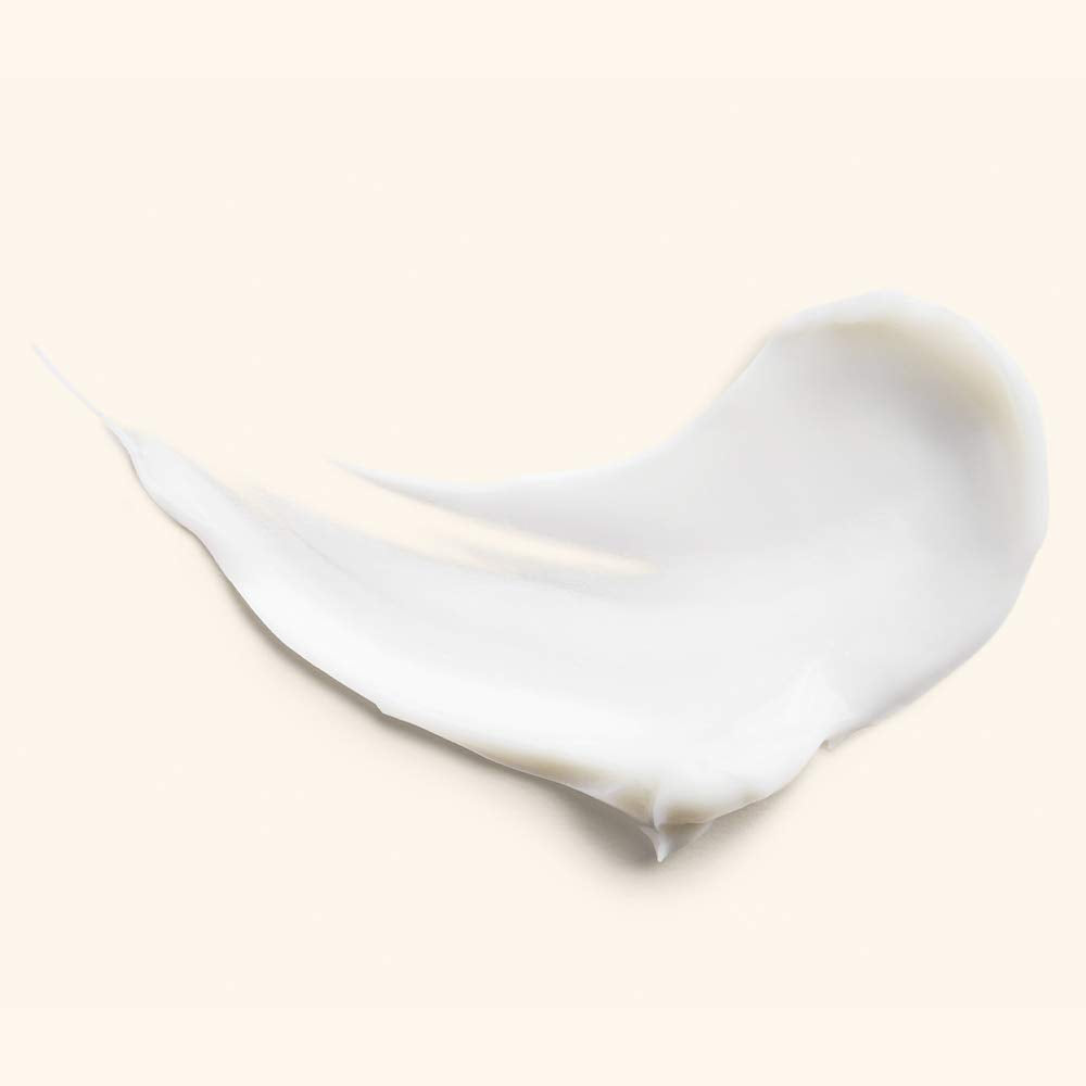 JLO BEAUTY Under Eye Cream application shot demonstrates gentle patting for daily use.
