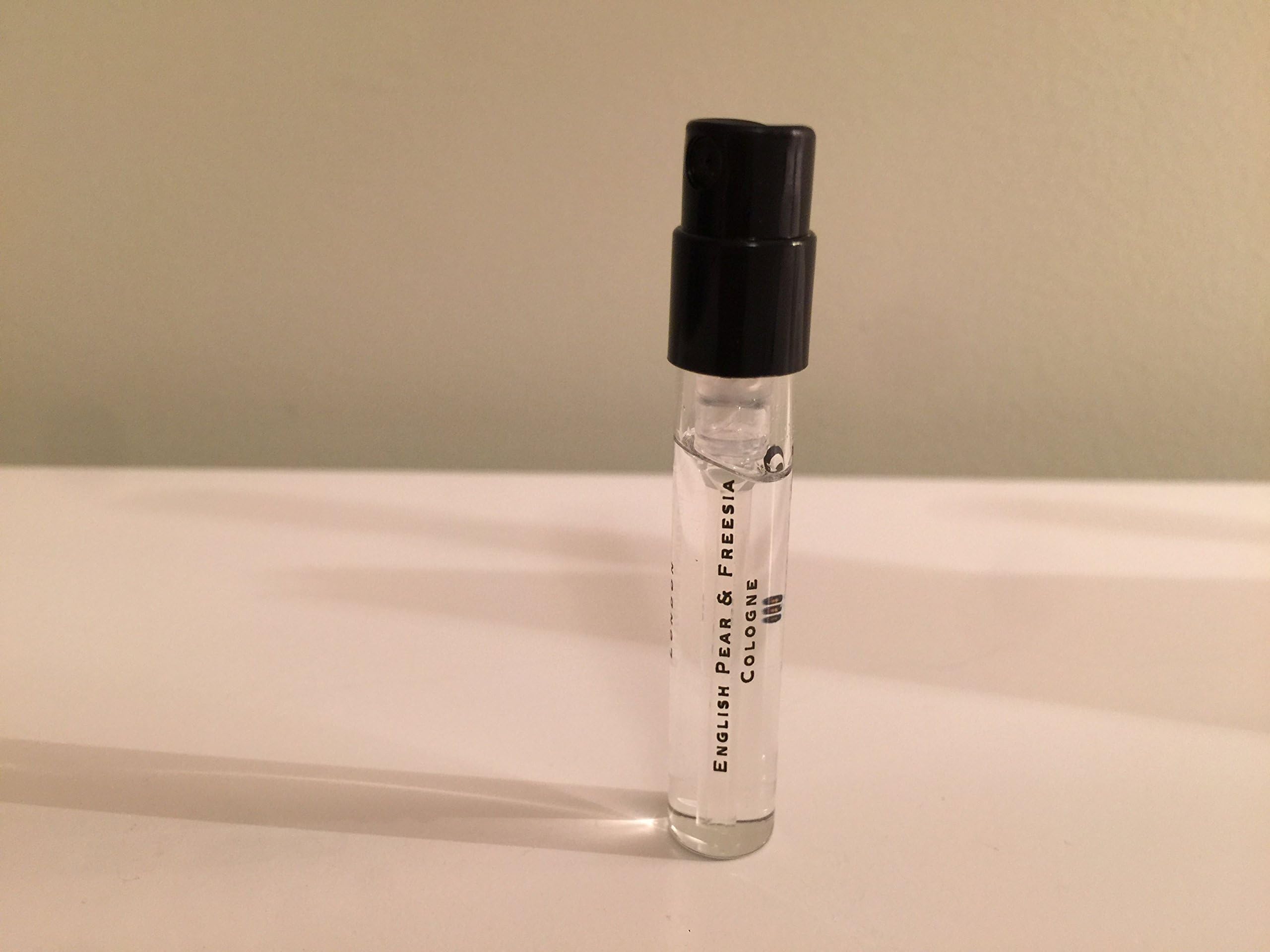 Jo Malone English Pear and Freesia travel-size packaging showcases portable luxury scent.