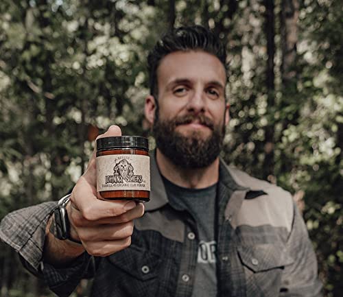Johnny Slicks hands applying pomade for a low-to-medium hold with manageability