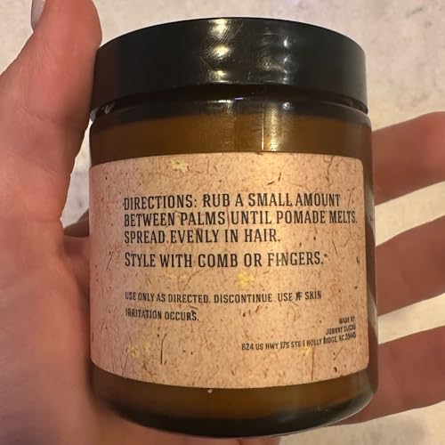 Johnny Slicks pomade is being smoothed into hair for easy styling and lasting hold.