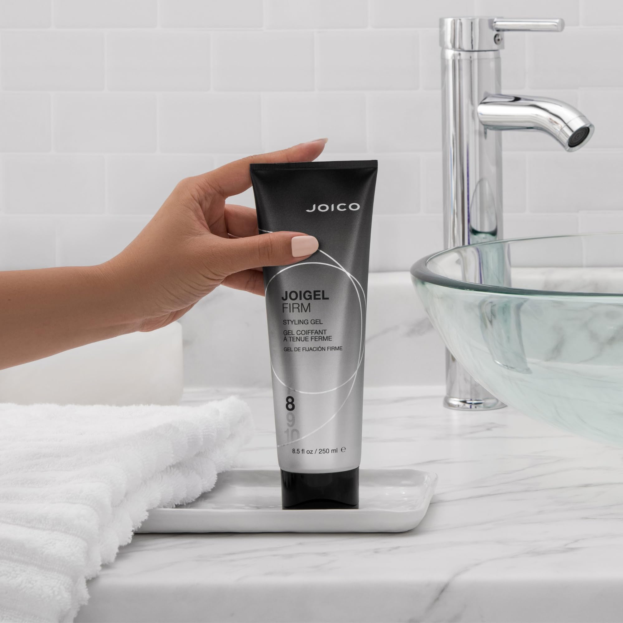 Joico JoiGel Firm bottle showing glossy shine and hydrated hair.