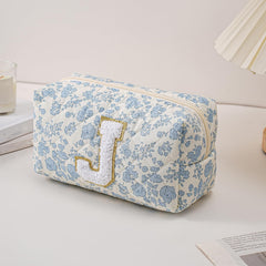 JOVAKIT Alphabet Makeup Bag blue floral open zip for easy access to cosmetics on the go.