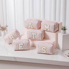 JOVAKIT alphabet makeup bag opened to show organization of cosmetics and tools