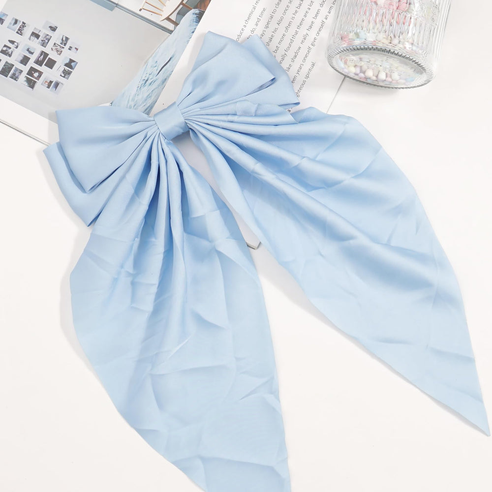 JOYOYO hair clip blue long bow on head offers charming versatile accessory.