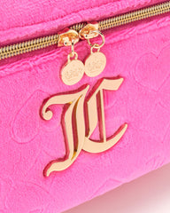 Juicy Couture hot pink case fits in luggage for easy packing.