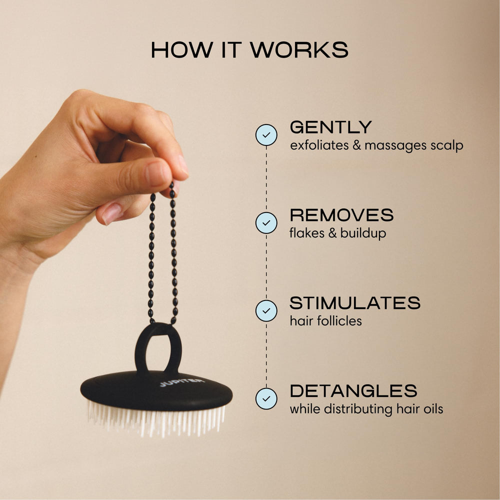 Jupiter scalp exfoliator finger ring grip demonstrating secure control and reduced slipping