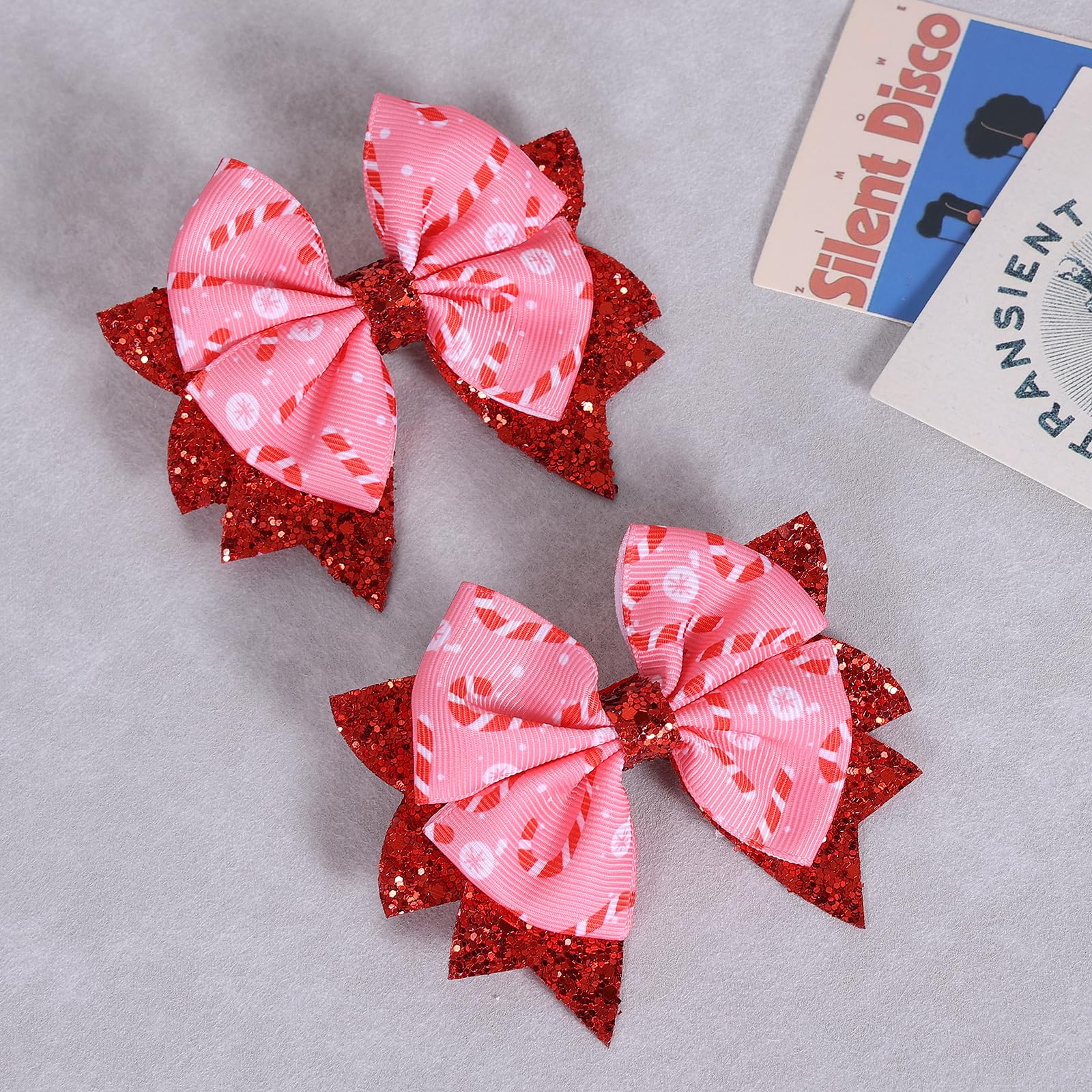 KCHIES Glitter Pink Candy Cane Bow Clip side view highlights durable PU leather shape.
