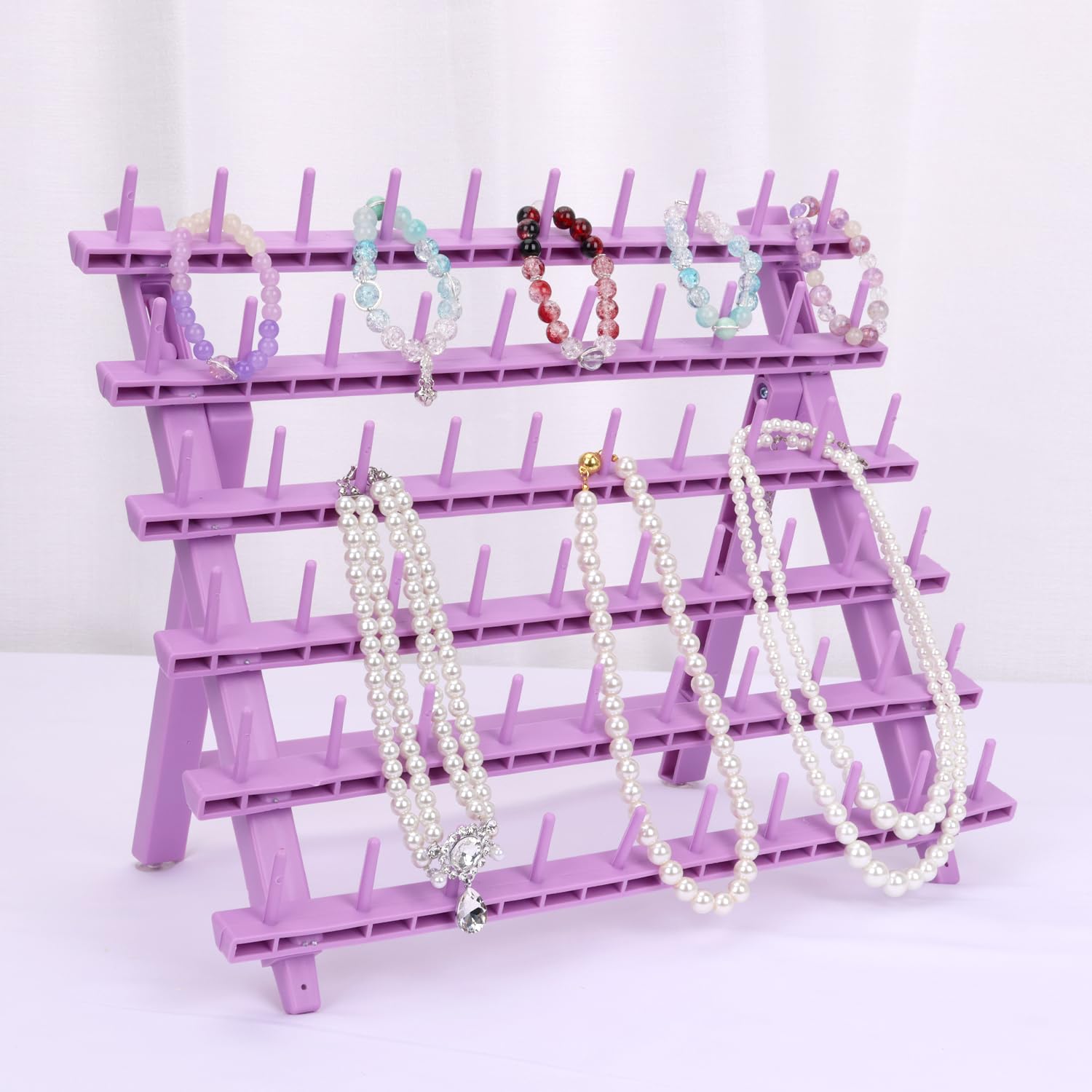 Kelukeya braid rack in use by stylist, easing hair piece selection