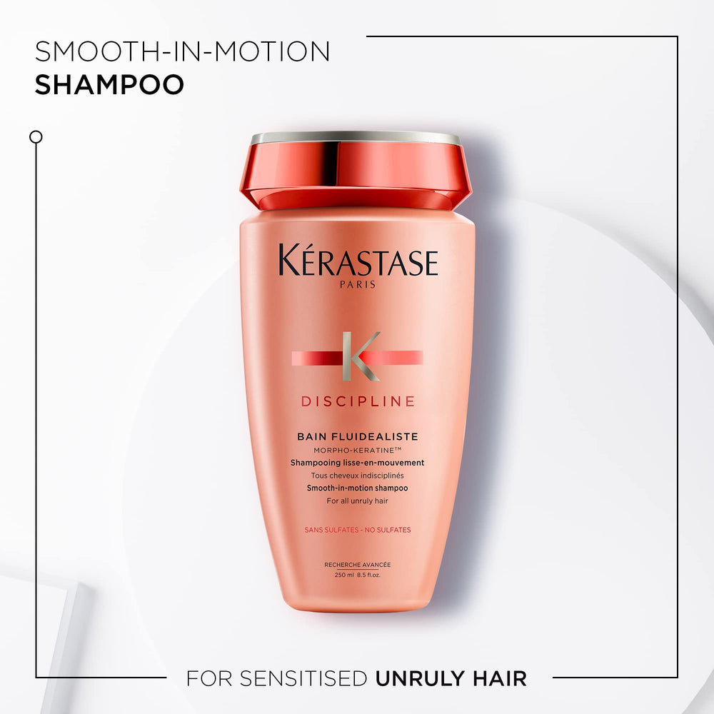 KÉRASTASE Discipline Bain Fluidealiste in hand delivering rich smoothing lather for frizzy hair.