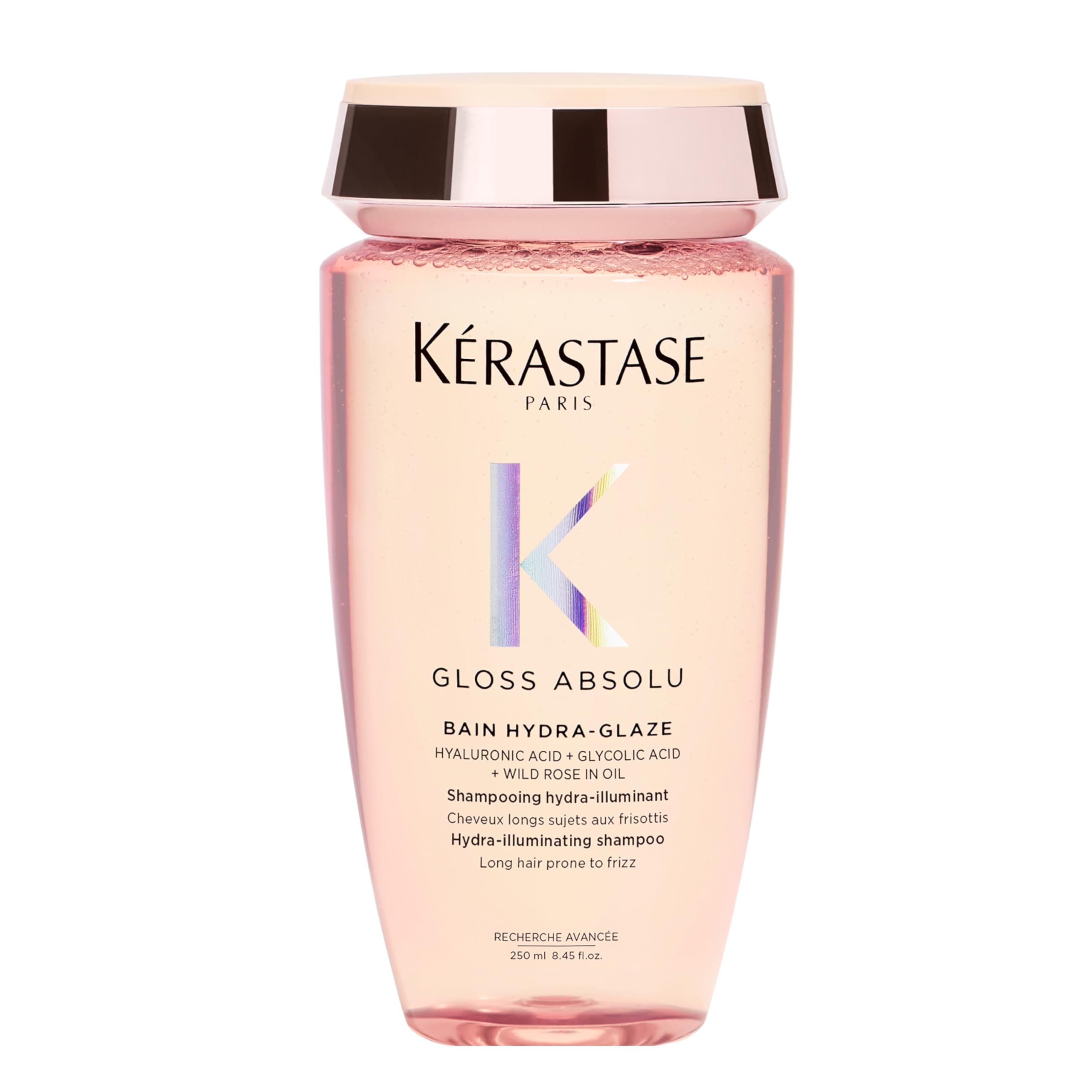 KÉRASTASE Gloss Absolu shampoo bottle closeup with hydrating, shine-boosting formula.