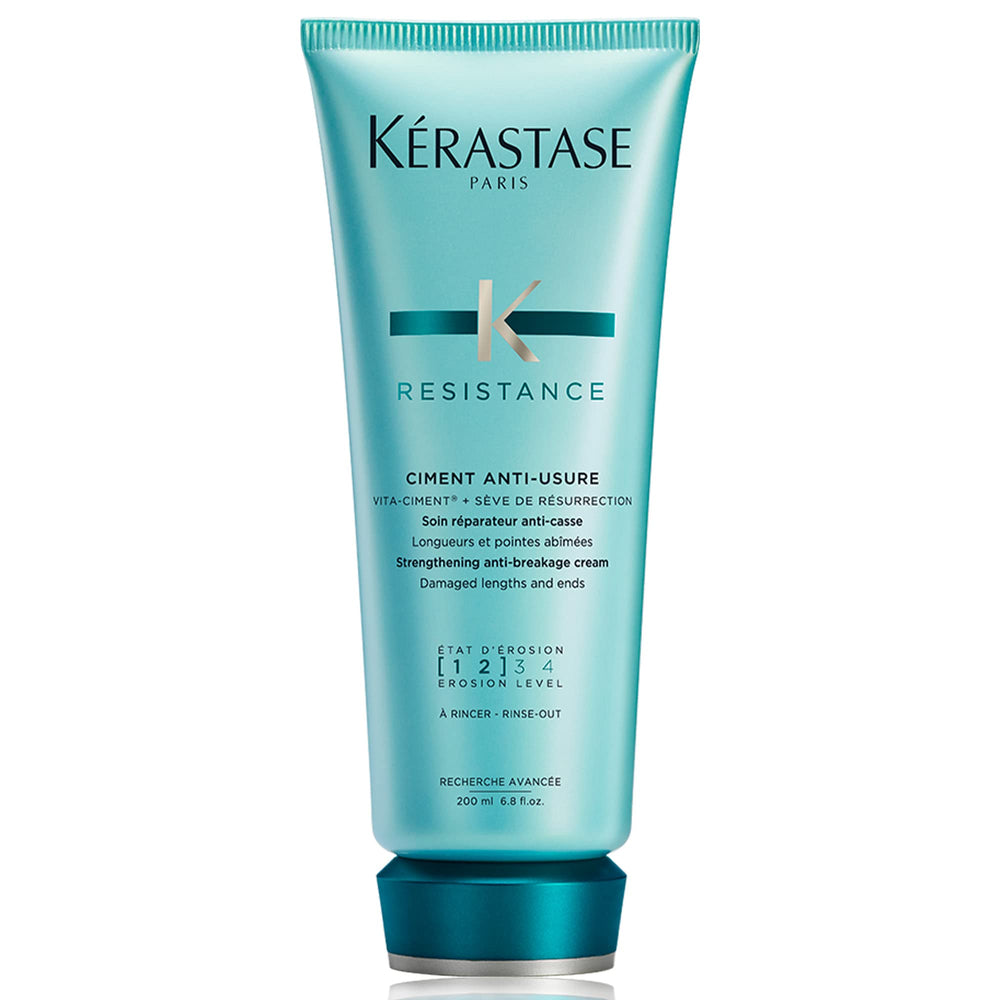 KÉRASTASE Resistance Ciment Anti-Usure bottle pouring, signaling restorative care for damaged hair