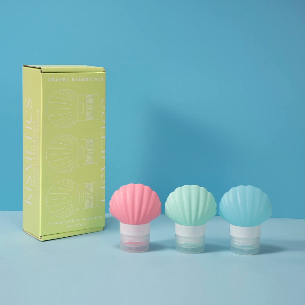 KISMETICS shell-shaped bottles arranged for organized carry-on packing