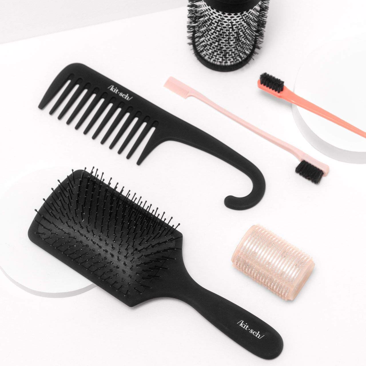 Kitsch wide-tooth detangler nine-inch-length highlights portable styling tool.
