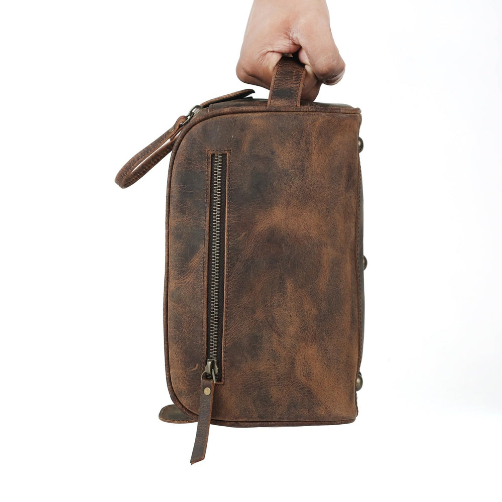KomalC leather toiletry bag water-resistant lining protects contents during travel.