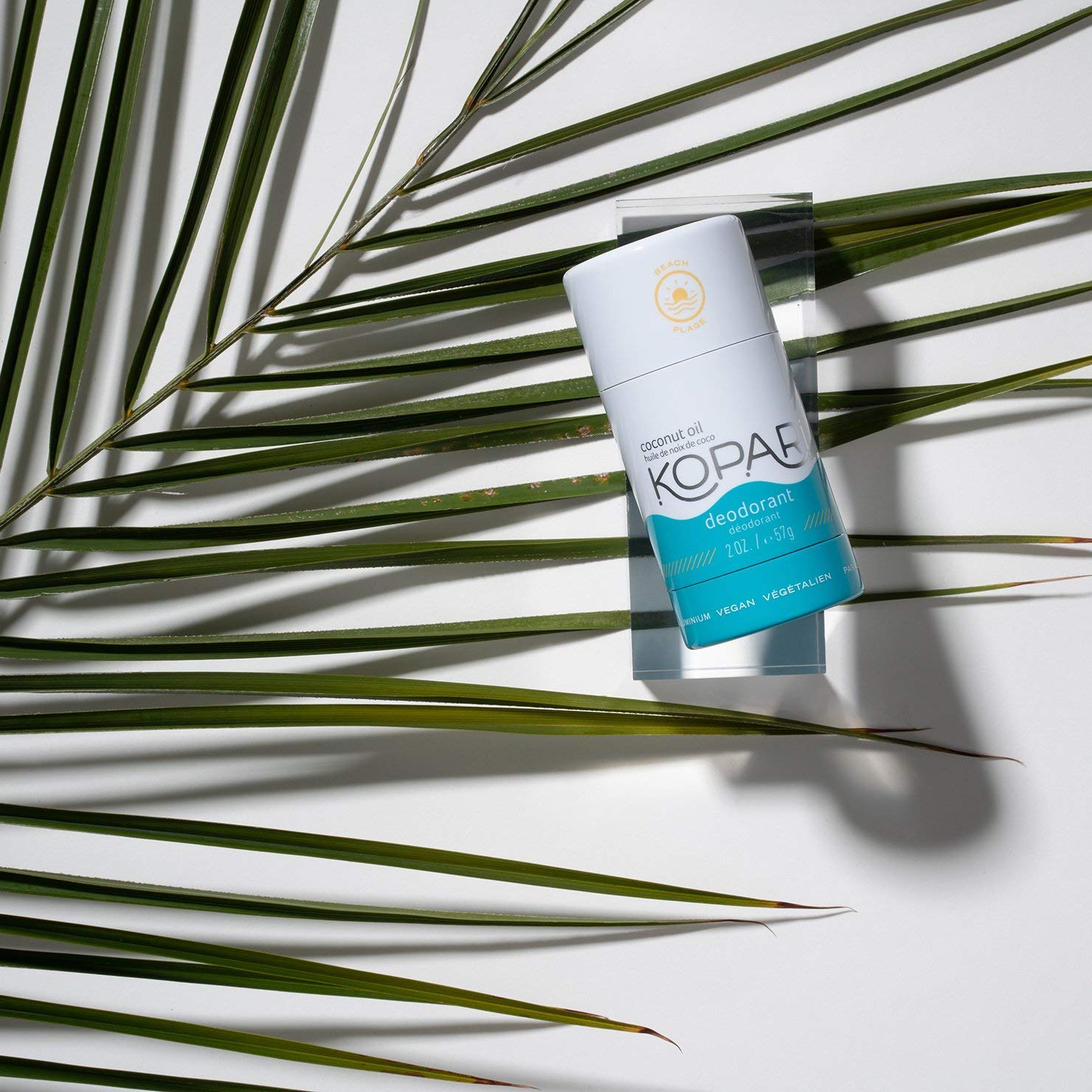 Kopari aluminum-free deodorant on skin demonstrates smooth clear glide.