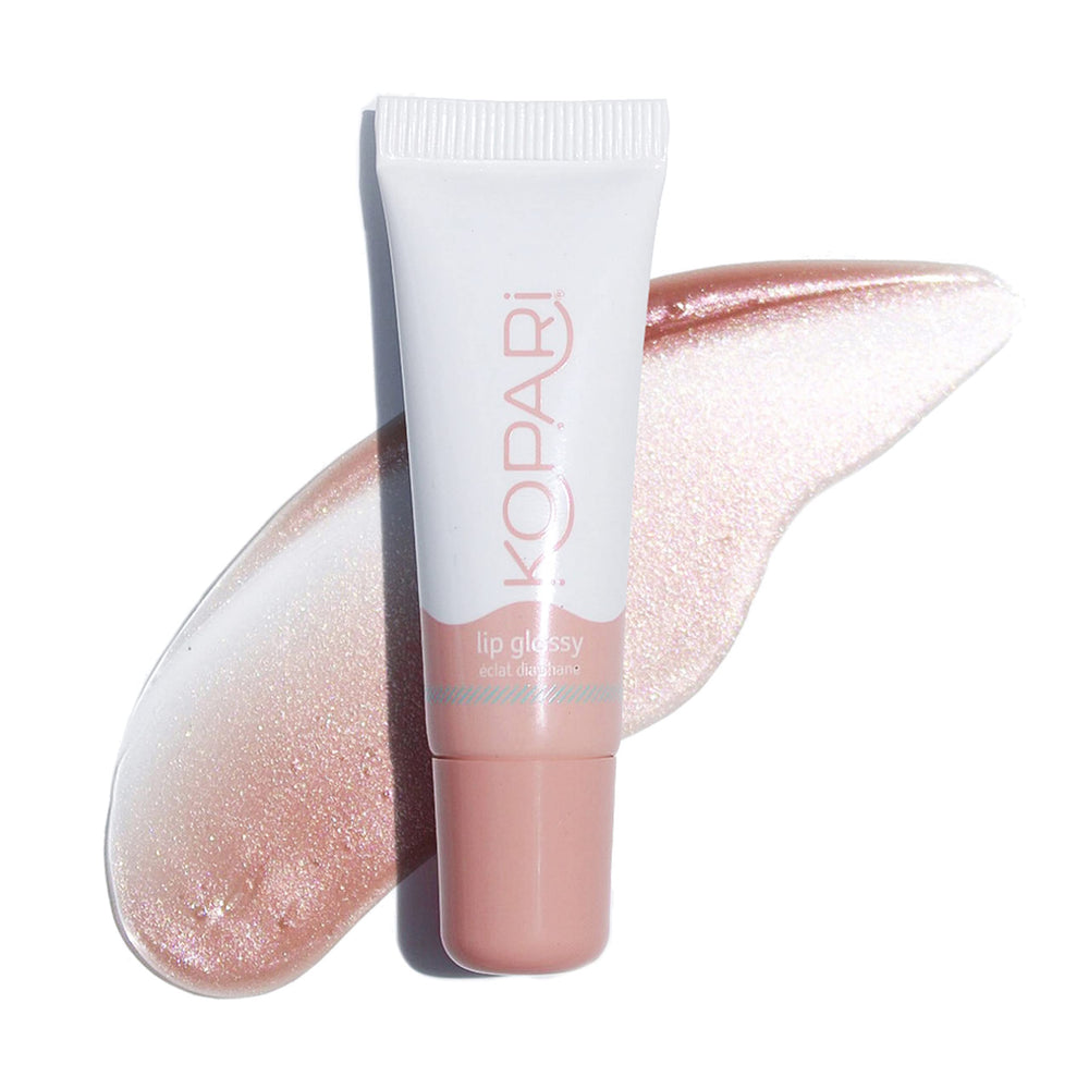 Kopari Coconut Lip Glossy nude tint birthday suit swatch shows natural glow and hydration.