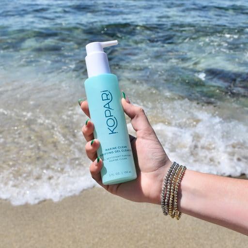 Kopari Marine Clean Purifying Gel Cleanser bottle dispensing, ready for makeup removal.