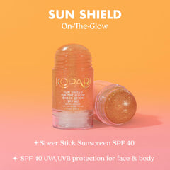 Kopari Sun Shield stick beside beach towel showing outdoor use